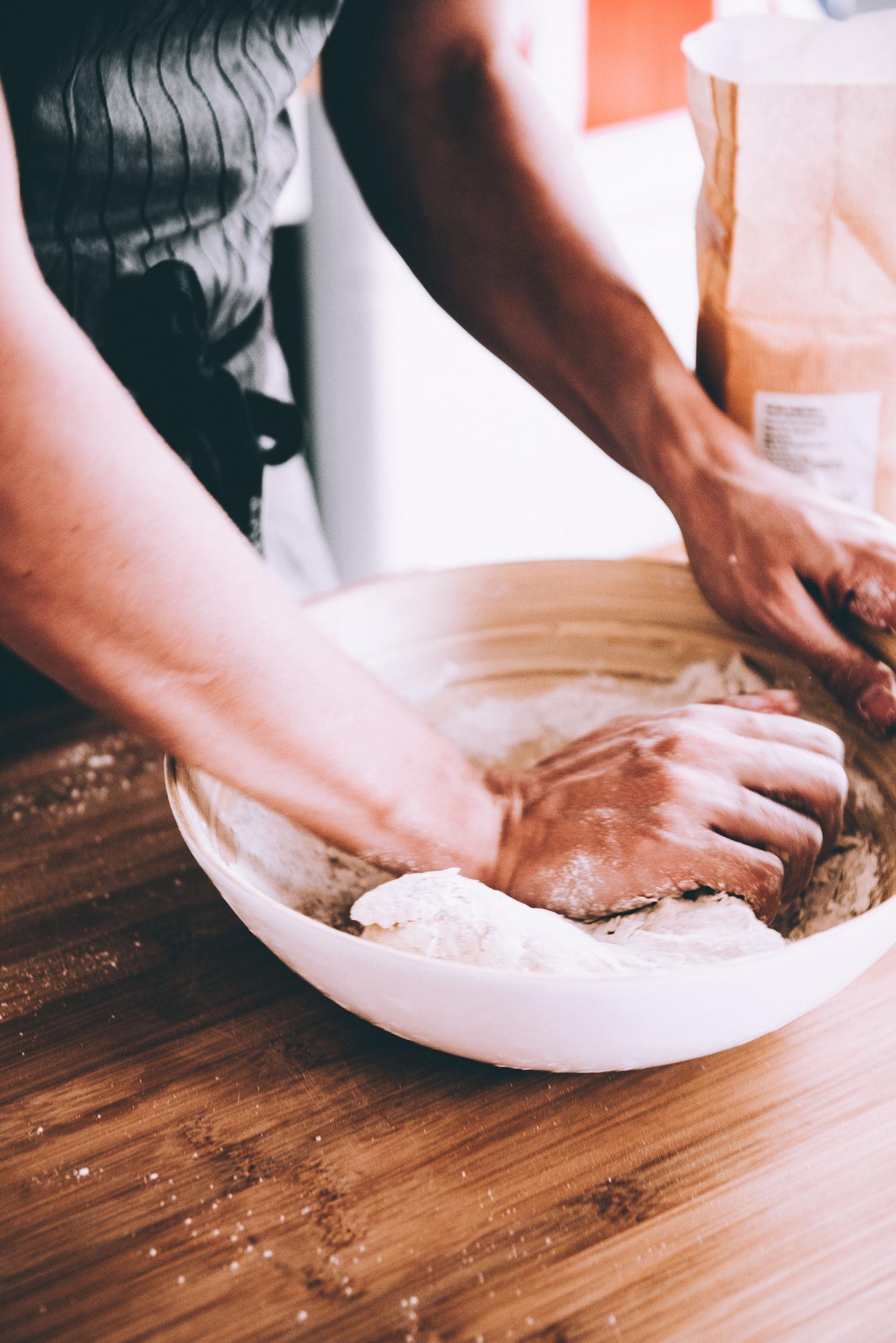 Close-up of hands kneading dough